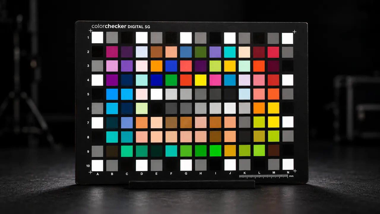 A physical colour reference chart illuminated in a dark photographic laboratory